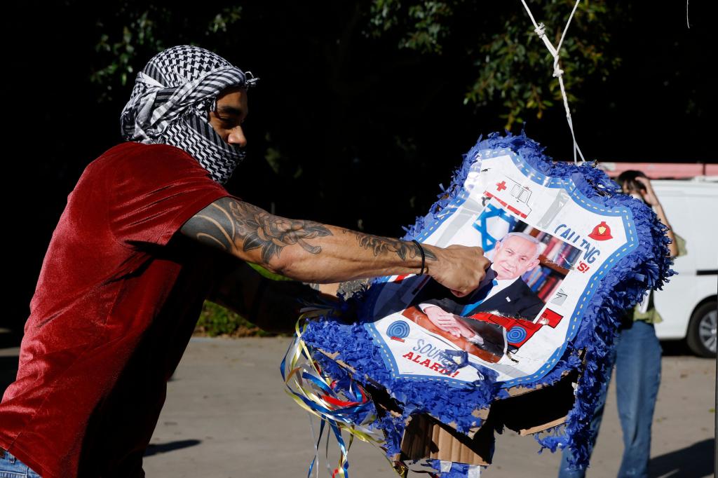 A protestor hitting a Benjamin Netanyahu piñata at UCLA on Nov. 8, 2023.
