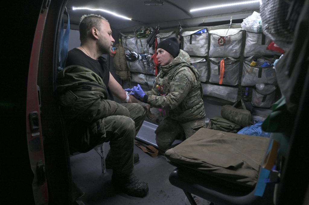 Ukrainian military medic Vasylyna (R), 28-years-old, of the 80th separate Air Assault brigade treats a wounded serviceman in a medical evacuation car in an undisclosed area in the Donetsk region on November 30, 2023, amid the Russian invasion of Ukraine. 