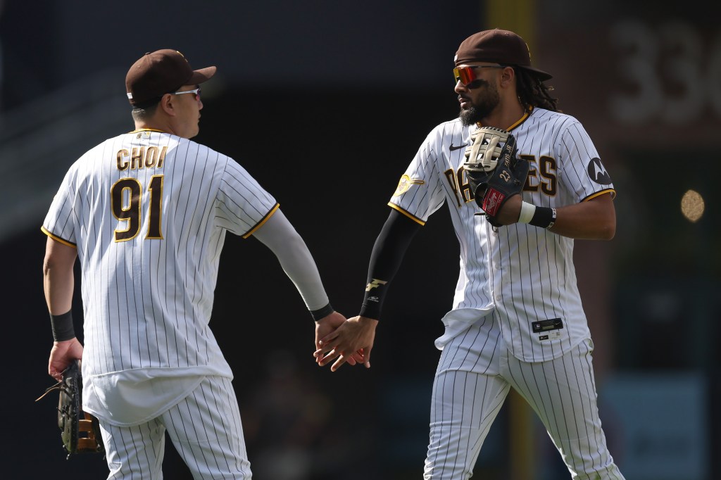 Ji-Man Choi #91 and Fernando Tatis Jr. #23 of the San Diego Padres celebrate after defeating the Colorado Rockies 3-2 in a game at PETCO Park.