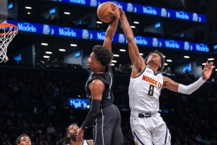 Dennis Smith Jr., who scored seven points and added five assists, goes up for a dunk during the Nets' 122-117 win over the Nuggets.