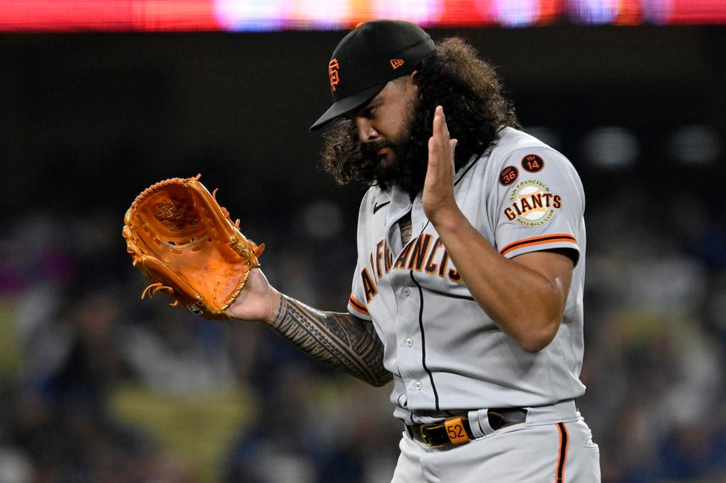 San Francisco Giants starting pitcher Sean Manaea applauds after getting Los Angeles Dodgers' Amed Rosario to fly out to left field during the seventh inning of a baseball game in Los Angeles, Friday, Sept. 22, 2023.