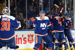 New Islanders Robert Burtozzo (right) celebrates with Ilya Sorokin after the Islanders' 3-2 overtime win over the Kings.