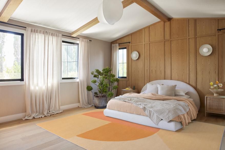 A room with a peach rug