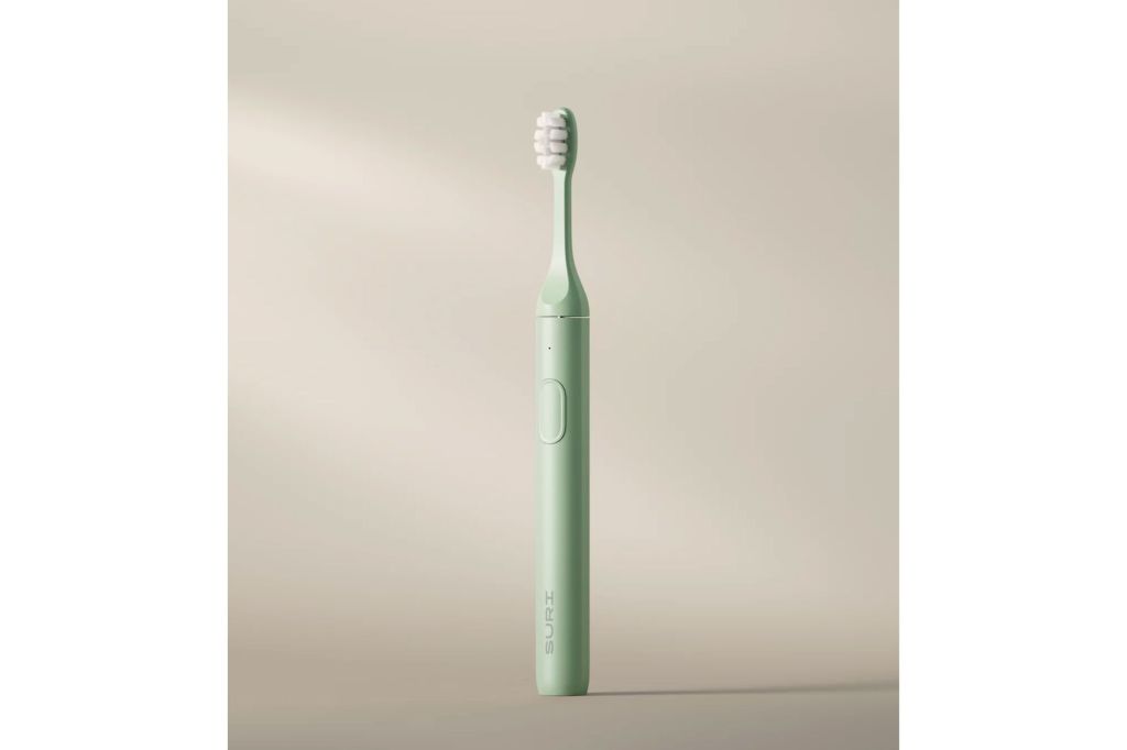 A green electric toothbrush