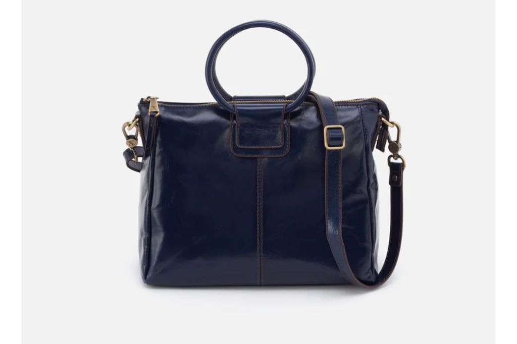 A navy blue patent leather purse.