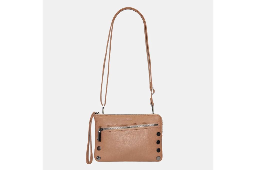 A small leather purse with studded detail and a removable  strap.