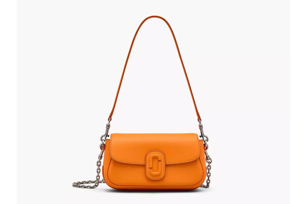 A small purse in the color orange.