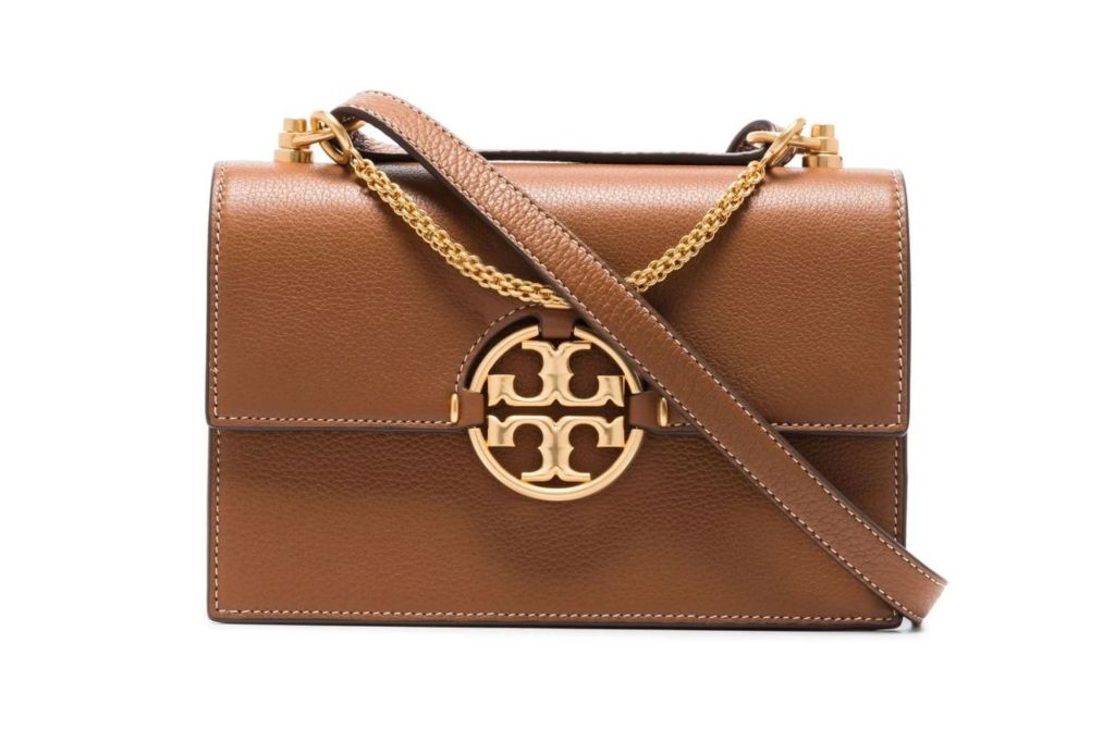 A brown Tory Burch purse with a shoulder strap.
