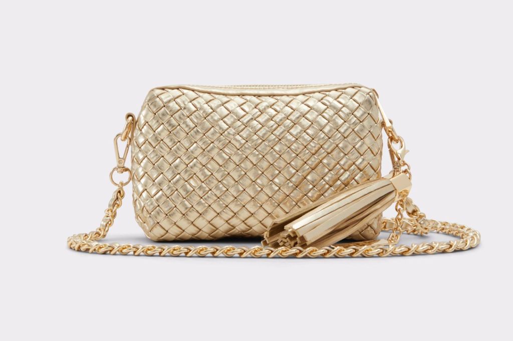 A metallic gold purse with tassels.