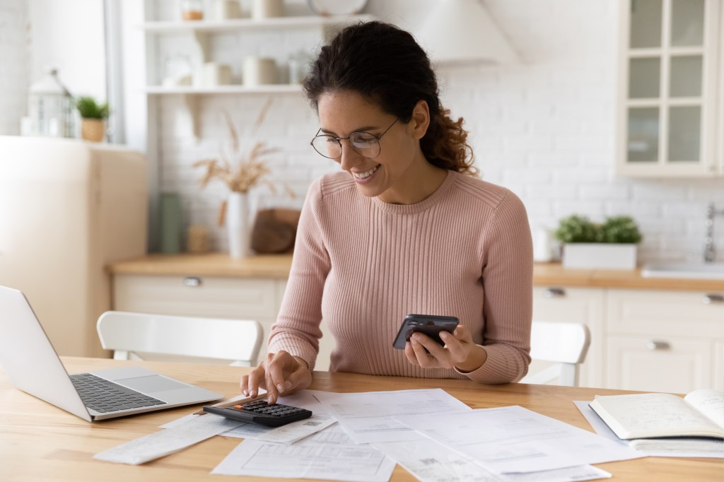 A woman calculates what saving account will earn her the most money.