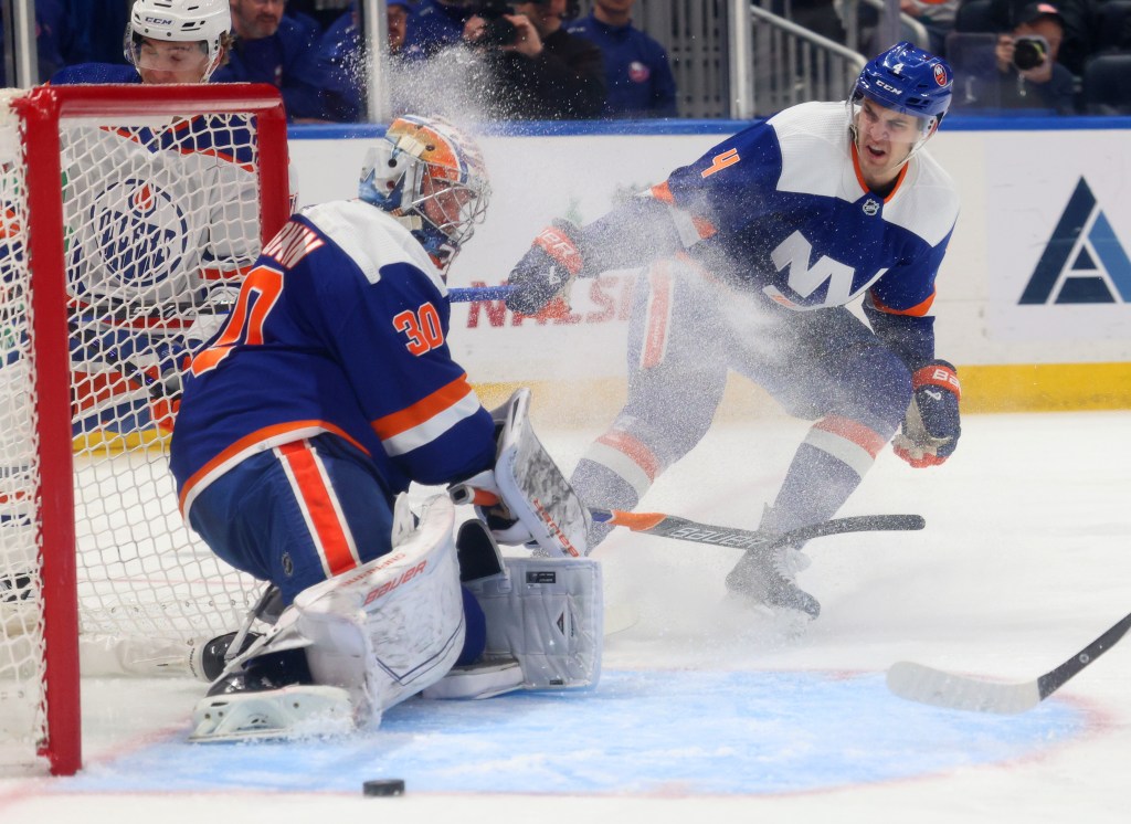 Samuel Bolduc (4) of the New York Islanders defends against Ryan McLeod (71) of the Edmonton Oilers as Ilya Sorokin (30) of the New York Islanders deflects the puck