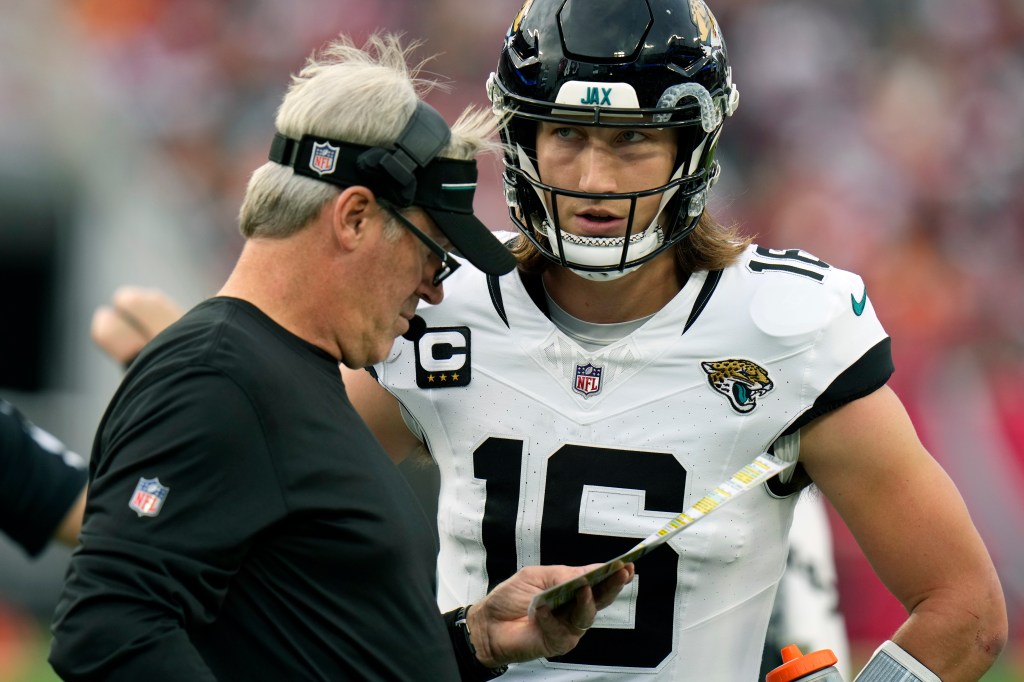 Trevor Lawrence talks with Jaguars coach Doug Pederson during a game against the Buccaneers on Dec. 24, 2023.