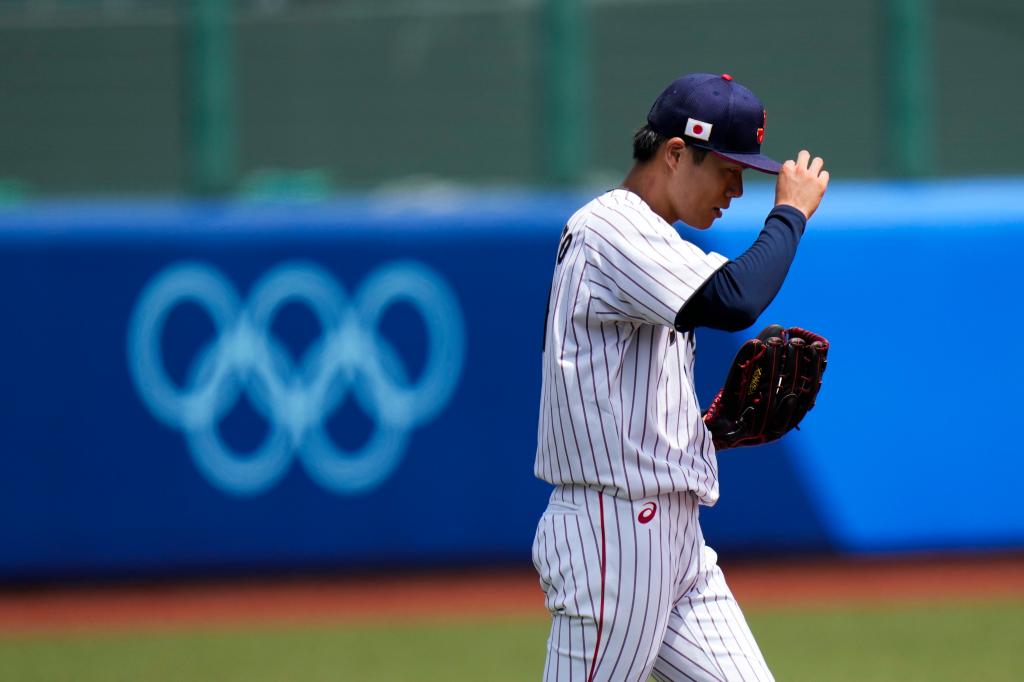 Japan starting pitcher Yoshinobu Yamamoto reacts after walking Dominican Republic's Emilio Bonifacio