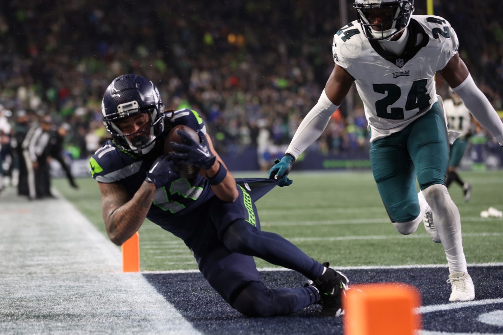 Jaxon Smith-Njigba #11 of the Seattle Seahawks catches a pass for a touchdown in the fourth quarter at Lumen Field.