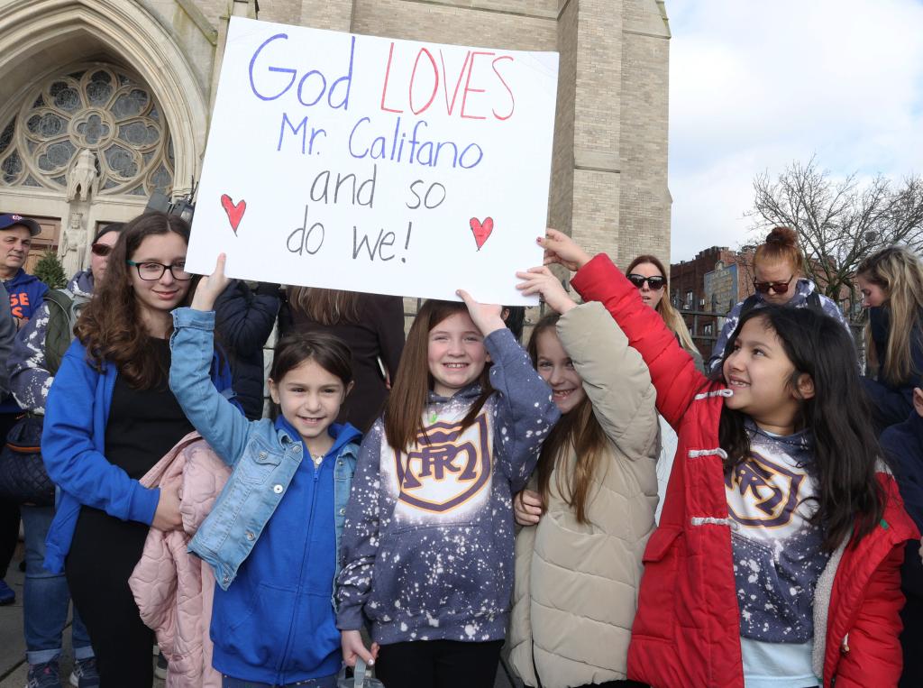 122923 Showing left to right holding sign: Liliana Mauceri 8, Nicole Burke 7, Mariella Huber 7, and Antonia Armienti 8. Family, Friends and Students at a Rally for Teacher Michael Califano, 26years old, at St. Agnes Cathedral at 29 Quealy Place in Rockville Center, Long Island. He was fired from the Church for not living there Lifestyle. "NYPostinhouse"