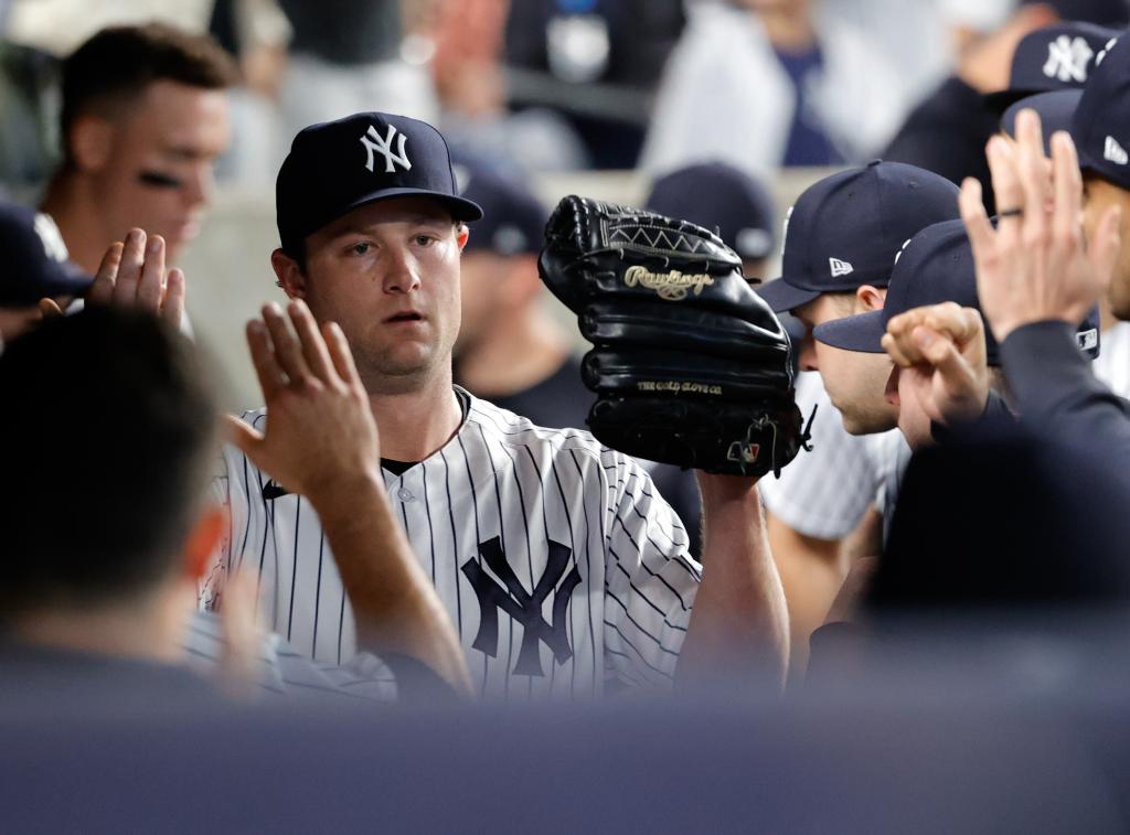 Yankees starting pitcher Gerrit Cole receives high-fives from his teamates in his teams dugout  during game action against the Toronto Blue Jays in the eighth inning.