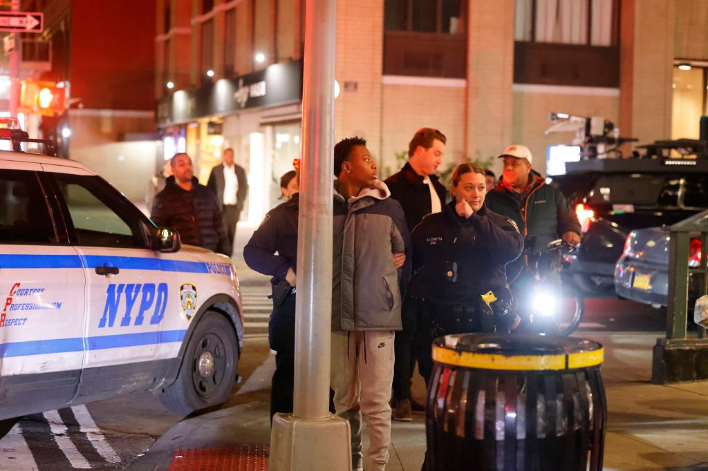 Detectives at the crime scene in Manhattan's Flatiron District.