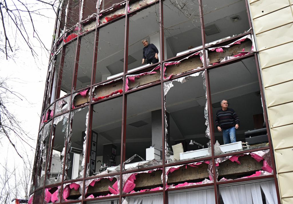 People remove debris inside a building housing a beauty salon, following recent shelling in the course of Russia-Ukraine conflict in Donetsk, Russian-controlled Ukraine, December 3, 2023.