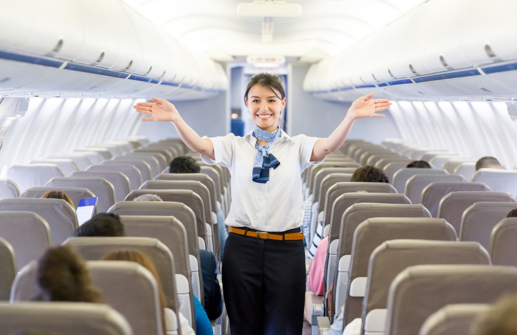 A flight attendant gives a safety demonstration.