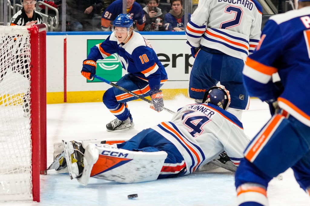 Islanders' Simon Holmstrom (10) reacts after shooting the puck past Edmonton Oilers goaltender Stuart Skinner 