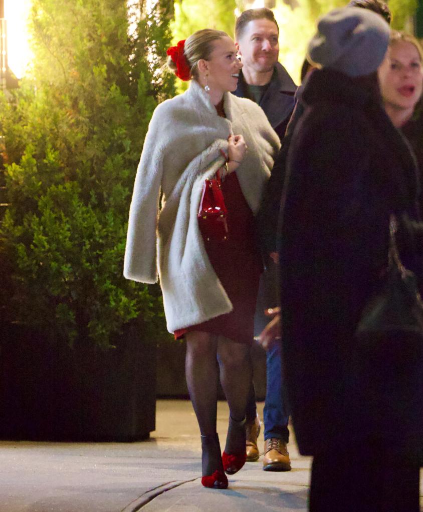 Scarlett Johansson greeting guests at her holiday party. 
