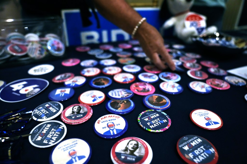 A supporter displays buttons in favor of President Joe Biden's reelection at at the Charleston County Democratic Party's Blue Jan on Saturday, Nov. 18, 2023