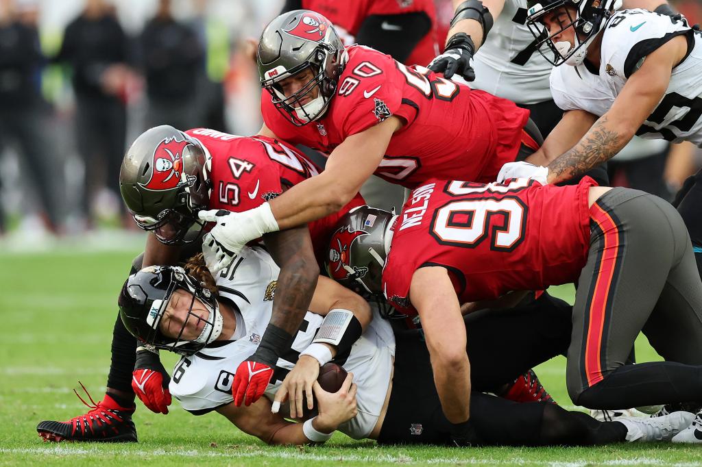 Jaguars quarterback Trevor Lawrence is sacked by the Buccaneers' Lavonte David on Dec. 24, 2023.