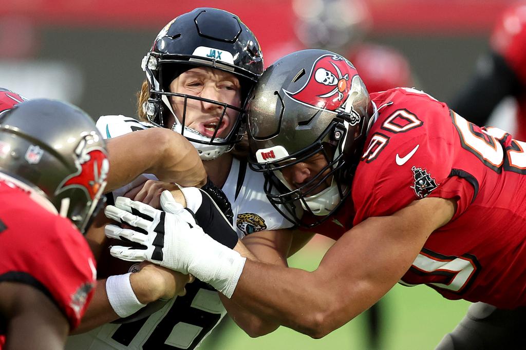 Jaguars quarterback Trevor Lawrence is hit by the Buccaneers' Logan Hall on Dec. 24, 2023.