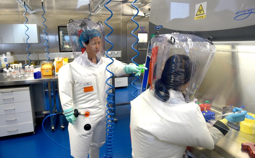 Virologist Shi Zheng-li, left, works with her colleague in the P4 lab of Wuhan Institute of Virology (WIV) in Wuhan in central China's Hubei province Thursday, Feb. 23, 2017.