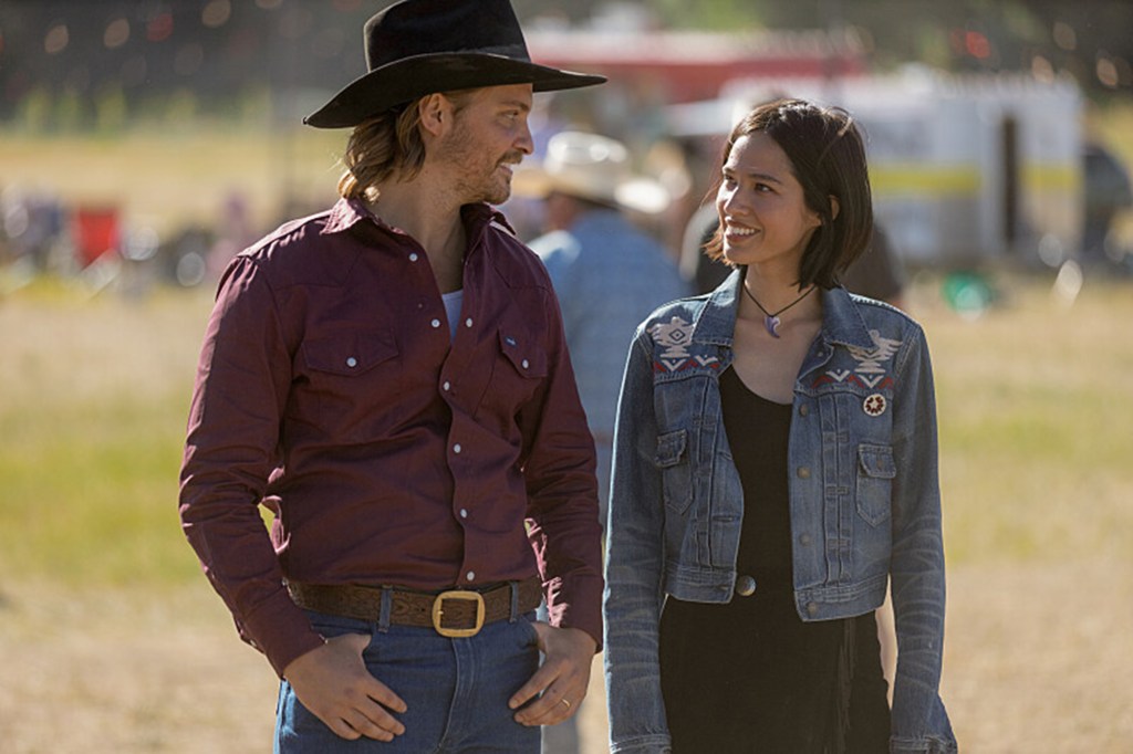 Kayce Dutton (Luke Frimes) and his wife Monica (Kelsey Asbille) smiling at each other. 