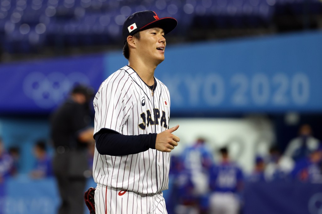 Yoshinobu Yamamoto #17 of Team Japan reacts as he walks back to the dugout