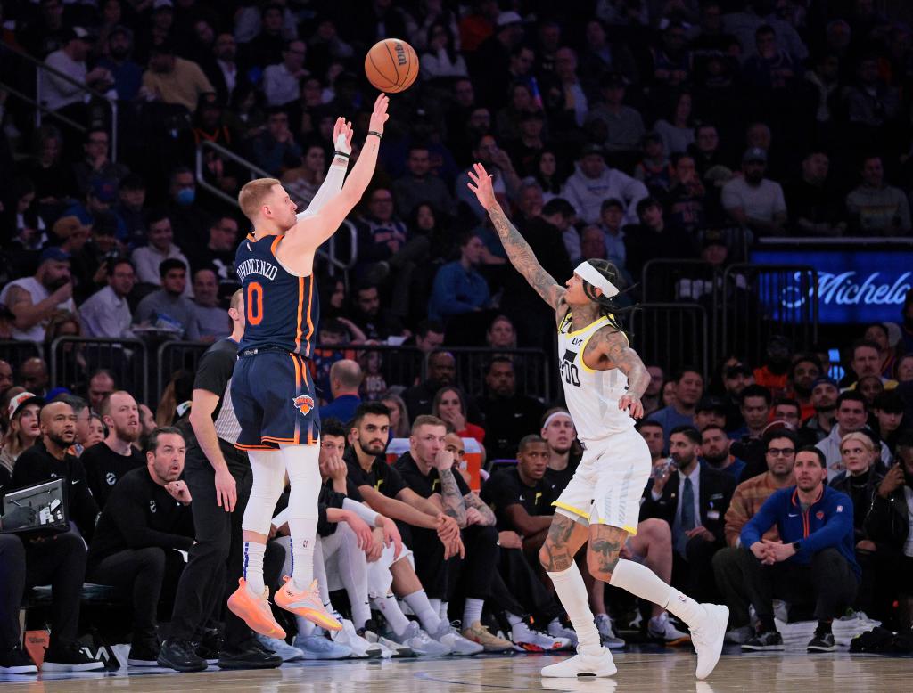 New York Knicks guard Donte DiVincenzo #0 puts up a shot over Utah Jazz guard Jordan Clarkson #00 during the second quarter.