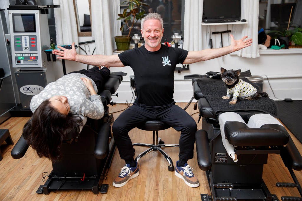 Chiropractor Doug Willen, 59, in his Fifth Avenue offices with patients Christie Park and her 12-year-old Yorkipoo, Rookie.  