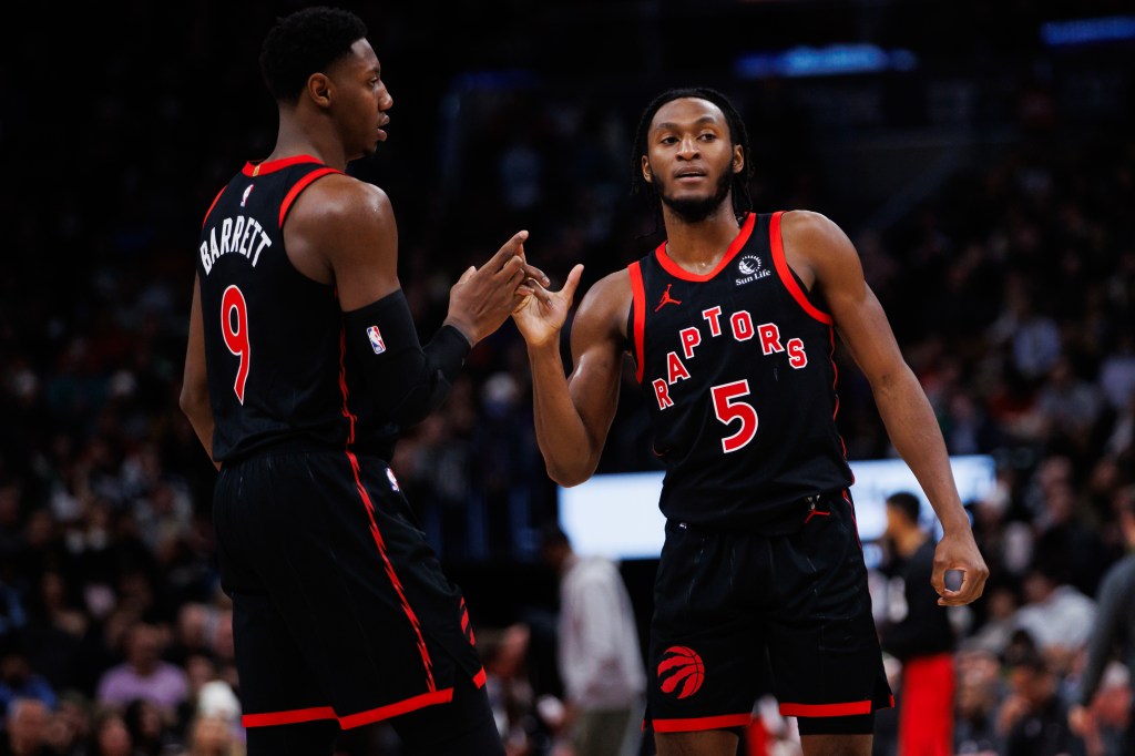  RJ Barrett #9 and Immanuel Quickley #5 of the Toronto Raptors react against the Boston Celtics