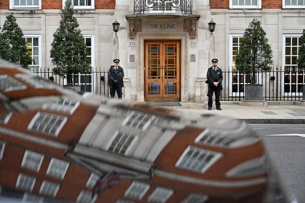 Police officers stand guard outside the London Clinic in London on January 17, 2024. 