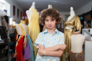 Max Alexander posing for portrait in front of mannequins