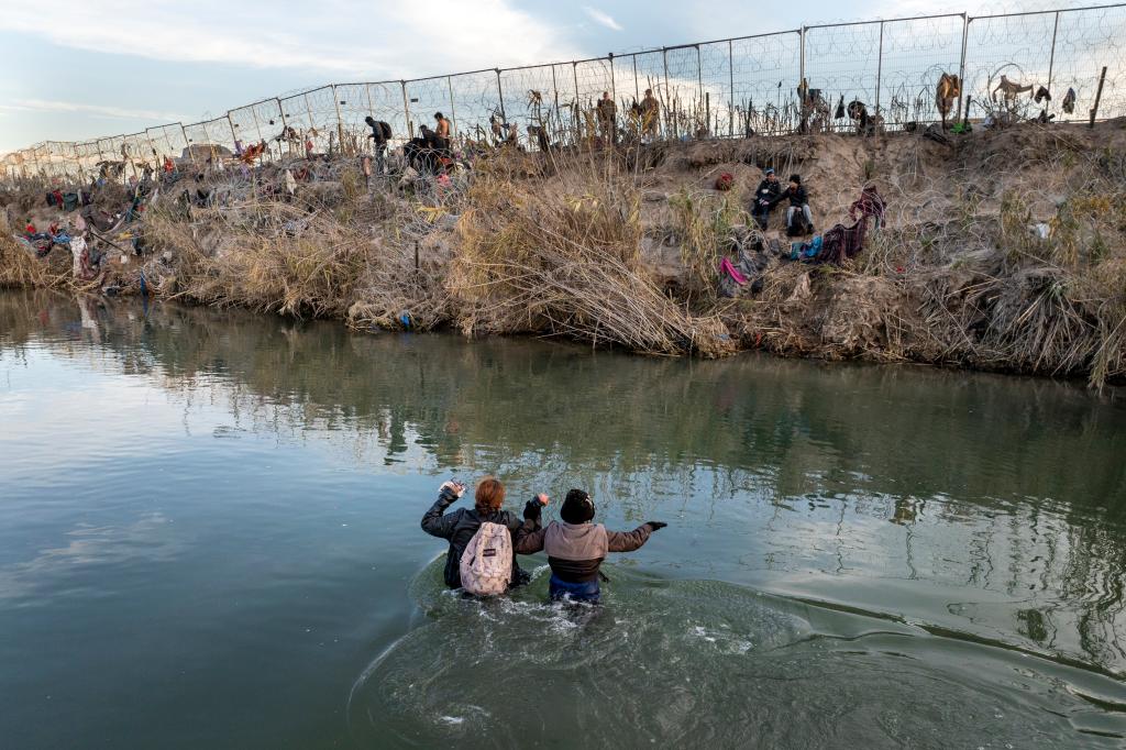 Migrants crossing the Rio Grande from Mexico towards the US border in Eagle Pass, Texas, on Sunday