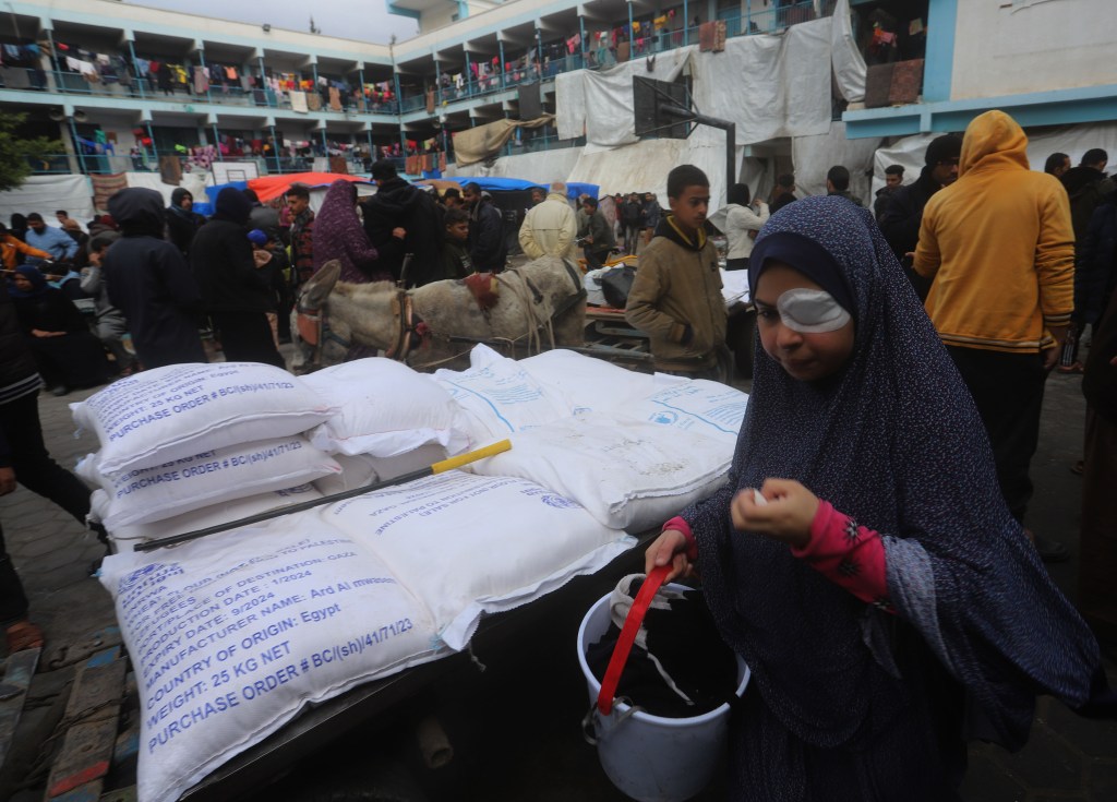 An Injured woman receives supplies from a UNRWA shelter in Rafa. 