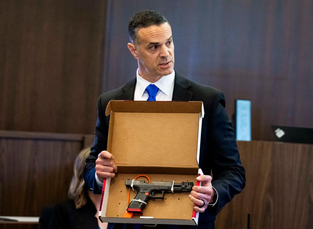 Feldman shows the jury a 9 mm handgun as part of the evidence against Eriz on Jan. 18, 2024.