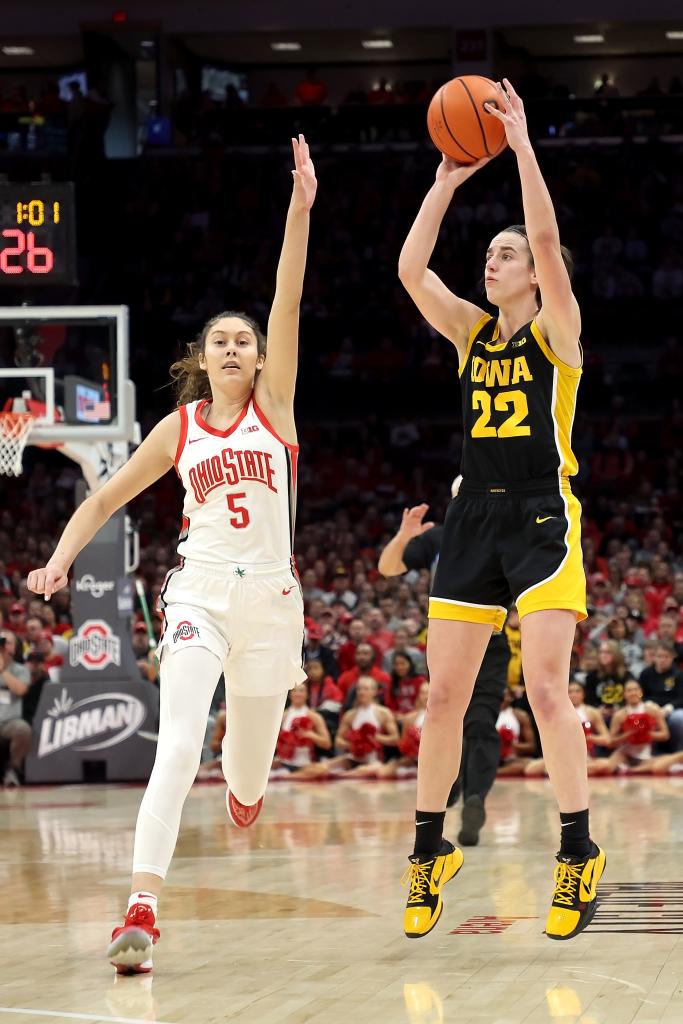 Caitlin Clark #22 of the Iowa Hawkeyes shoots a three-point shot over the defense of Emma Shumate #5 of the Ohio State Buckeyes during the third quarter of the game at Value City Arena on January 21, 2024 in Columbus, Ohio. 