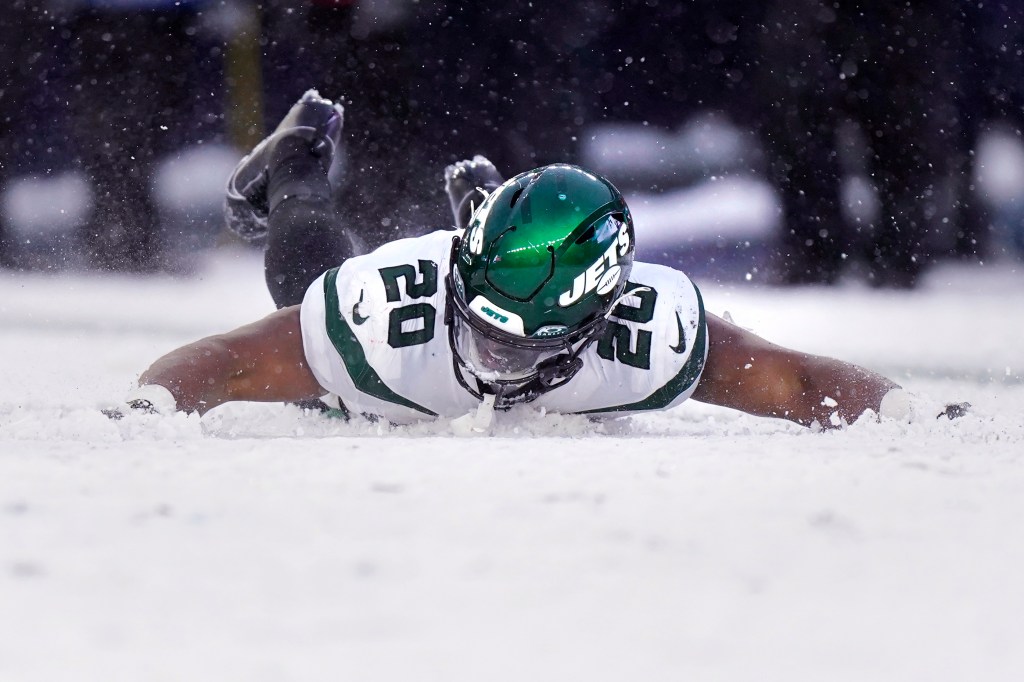 Jets running back Breece Hall makes snow angels following his touchdown against the Patriots during the second half.