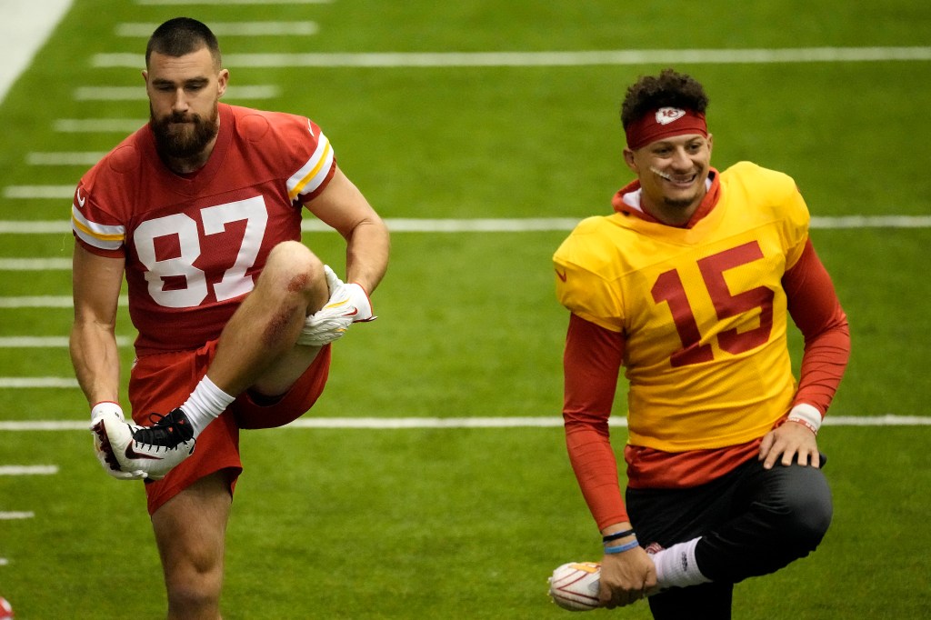 Kansas City Chiefs tight end Travis Kelce (87) and quarterback Patrick Mahomes (15) stretch during practice Wednesday, Jan. 24, 2024, in Kansas City, Mo.  