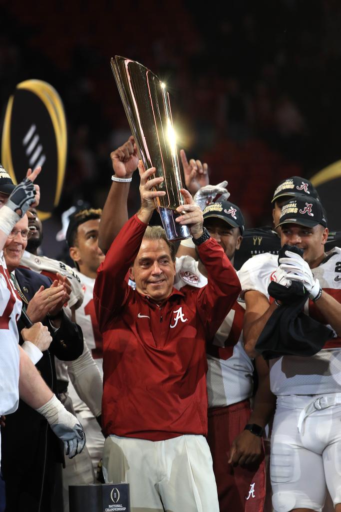 Nick Saban of the Alabama Crimson Tide holds the trophy while celebrating with his team after defeating the Georgia Bulldogs in overtime to win the CFP National Championship presented by AT&T at Mercedes-Benz Stadium on January 8, 2018.