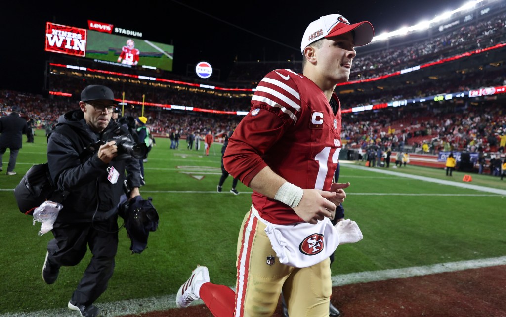 Brock Purdy runs off the field after the 49ers' win over the Packers in the NFC divisional round.