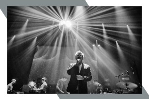 LCD Soundsystem's James Murphy sings in front of a glowing disco ball.