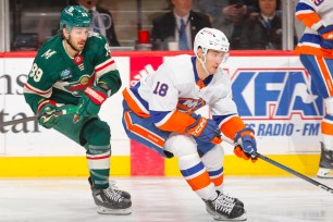 Pierre Engvall skates with the puck as Frederick Gaudreau defends during the Islanders' 5-0 loss to the wild earlier in the month.