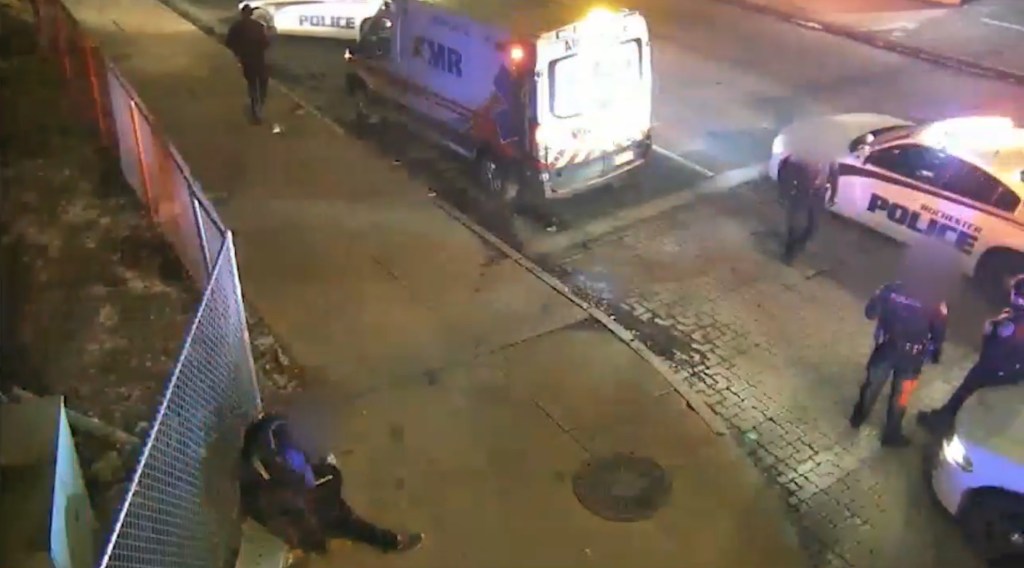 Moments after exiting the ambulance, the man passes out on the sidewalk.