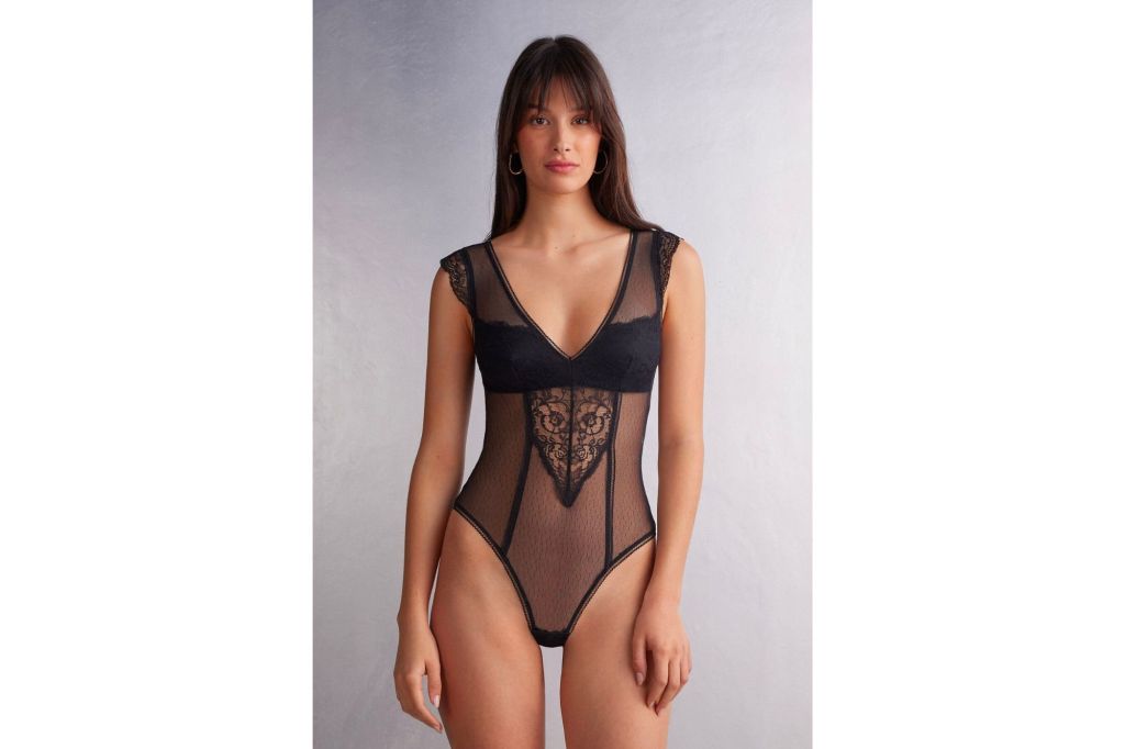 A woman in a sheer bodysuit