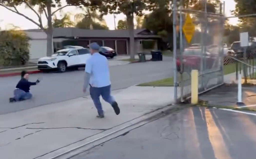 Victim is seen getting to her feet after being knocked to the ground by the car