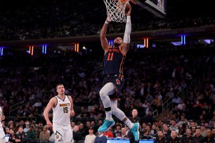 Jalen Brunson elevates for a dunk against Nikola Jokic and the Nuggets during the Knicks' win Thursday.